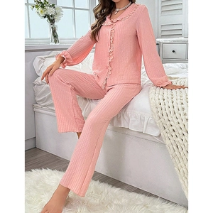 Pink waffle texture pajama set with elegant ruffle trim on collar and cuffs for women