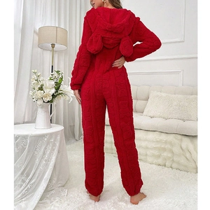 Macro view of plush red Sherpa fleece fabric with 3D embossed bear patterns on hooded pajamas