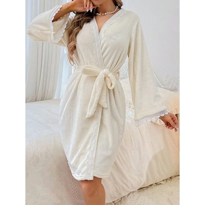 Close-up of white coral fleece bathrobe featuring elegant V-neck and lace trim detailing