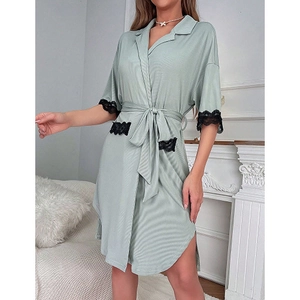 Detail of light green short sleeve sleepwear with black lace trim and waist tie strap