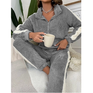 Detail of dark grey sherpa fleece loungewear with zipper collar and side stripe pattern