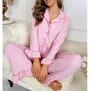 Detail showing pink ribbed pajama set with ruffle trim and button-down lapel