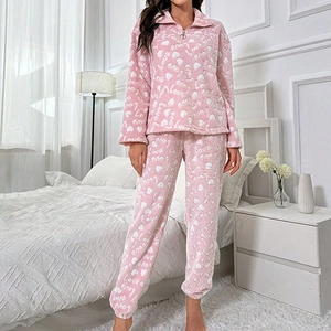 Pink fleece pajamas set with heart and Love patterns featuring quarter-zip top and pants
