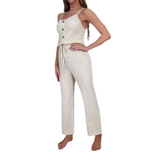 Beige ribbed knit sleeveless jumpsuit with drawstring waist and wide leg design