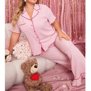 Pink waffle texture pajama set with short sleeve button-up top and long pants for women
