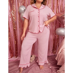 Detail of pink plus-size pajama set featuring button-down shirt and ruffled hem pants