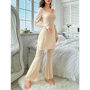 Elegant beige two-piece lounge set with long-sleeve lace-up top and flare pants