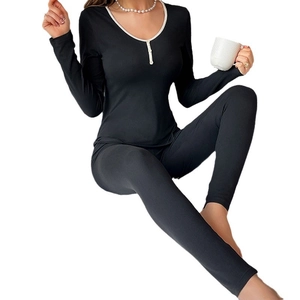 Women's black thermal pajama set with contrast trim henley top and slim leggings