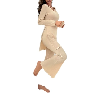Elegant beige long-sleeve pajama set featuring side slits and matching flared lounge pants
