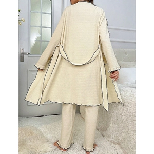Three-piece beige loungewear set with black piping and ruffle details on back view
