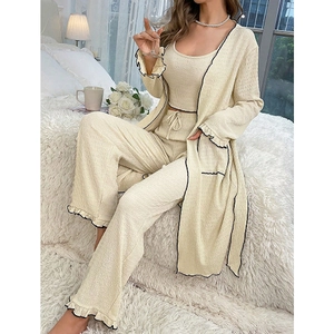 Three-piece off-white loungewear set featuring seersucker fabric and black wavy trim details
