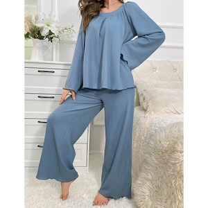 Detail of waffled texture fabric and lettuce hem on soft blue long-sleeve loungewear set