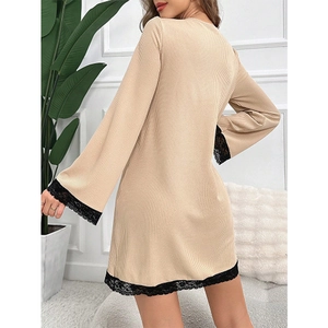 Beige ribbed long-sleeve nightgown with black lace trim hem in minimalist home setting