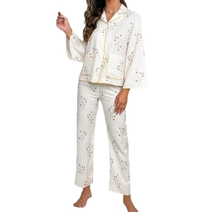 Floral pajama set with long sleeves and pants featuring yellow satin piping details