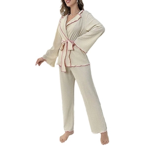 Women's cream loungewear set with textured fabric, kimono style tie-waist and red wavy trim