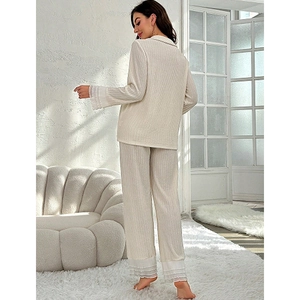 Women's two-piece cream pajama set with lace trim and elegant pleated texture