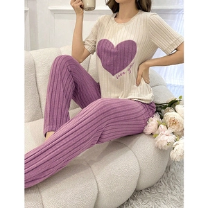 Women's pajama set featuring heart print top and purple ribbed pants in cozy fabric
