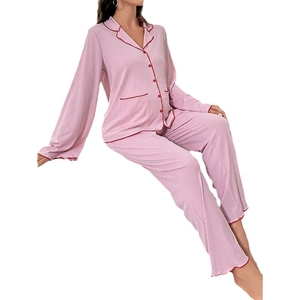 Pink maternity pajama set with long sleeves and red contrast piping on white background