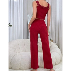 Women's burgundy knit lounge set featuring a lace-trimmed tank top and high-waisted pants
