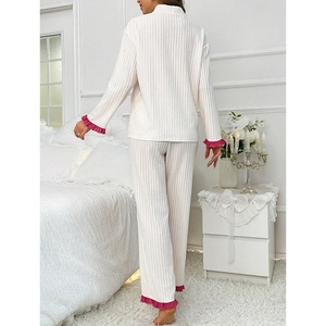 White ribbed pajama set with long sleeves and pink lettuce trim shown from a back view