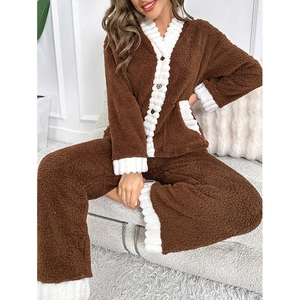 Detail of plush brown V-neck flannel pajamas with textured white piping and soft material