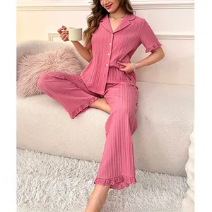 Detailed view of the delicate lace hem on pink ribbed pajamas for women's home wear