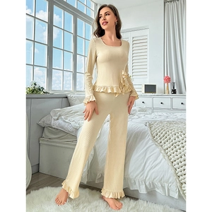 Two-piece ruffled loungewear set in beige featuring ribbed texture and long sleeves