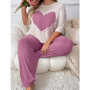 Close-up of ribbed pajama set featuring heart embroidery and purple cuffed trousers