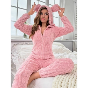 Detailed close-up of pink fluffy hooded pajamas featuring cute bear ears and plush fabric