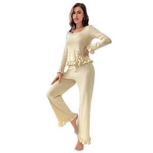 Cream ruffle trim rib-knit pajamas set featuring long sleeve top and wide-leg trousers