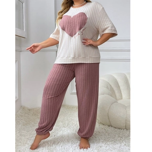 Detail of soft ribbed pajama set featuring pink heart print and love you lettering