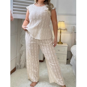 Close-up of cream lace pajama set showing floral embroidery and hollow-out texture