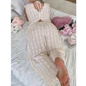 Elegant two-piece beige lace pajama set featuring backless lace top and matching trousers