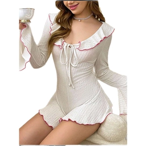White ribbed long sleeve one-piece pajama with ruffled pink trim and tie neckline