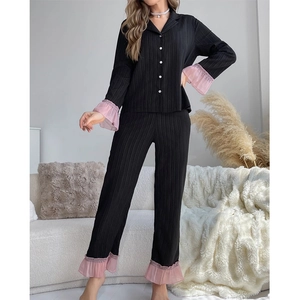 Women's pleated black pajama set with pink lace trim, long sleeves and button-down front