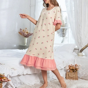 Close-up of pink tulip print fabric and layered ruffle hem on a cream nightdress