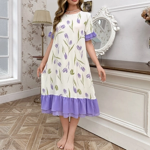 Detail of the purple tulip floral print and ruffle hem on the white lounge dress