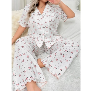 Detail of floral pajama set featuring pink ruffle trim and breathable ribbed fabric