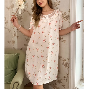 Close-up of cream lace neckline with bow and floral print on sweet nightdress