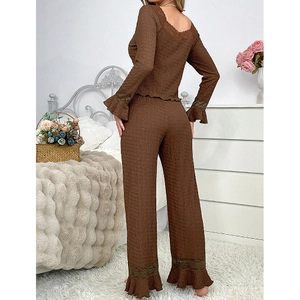 Detailed view of the back and side of brown lace loungewear with ruffled hem and cuffs