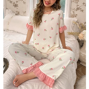 Women's two-piece floral pajama set with tulip prints and pink ruffle trim details