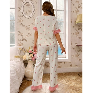 Women floral pajama set with short sleeve top and pants featuring pink ruffled trim