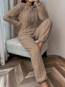 Detail of oatmeal coral fleece jumpsuit with plush texture and cozy hooded design
