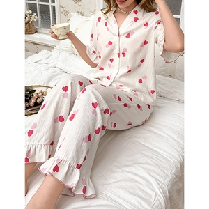Close-up of heart print pajama set with ruffle trim sleeves and vintage V-neck buttons