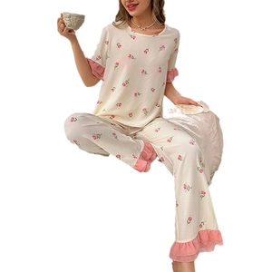 Women's floral pajama set with round neck short sleeves and pink ruffle trim details
