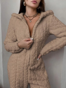 Detailed texture of thick camel coral fleece on a hooded warm hooded jumpsuit