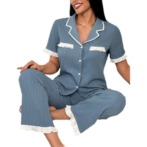 Women's blue waffle texture pajama set with white ruffle trim and button-up lapels