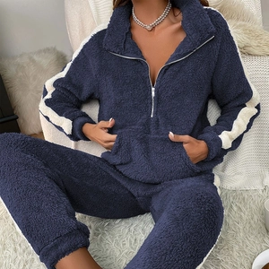 Women's dark blue fleece pajama set with half-zip top and striped trousers for winter comfort