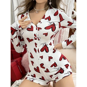 Detail of V-neck long sleeve romper with red heart print and button-down closure