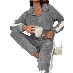 Women's coral fleece pajama set with grey half-zip top and striped trousers for winter